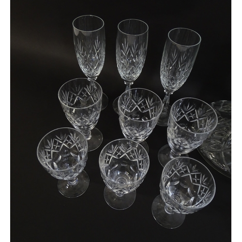 303 - A large quantity of cut glass / crystal glassware to include champagne flutes,  assorted drinking gl... 