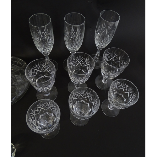 303 - A large quantity of cut glass / crystal glassware to include champagne flutes,  assorted drinking gl... 