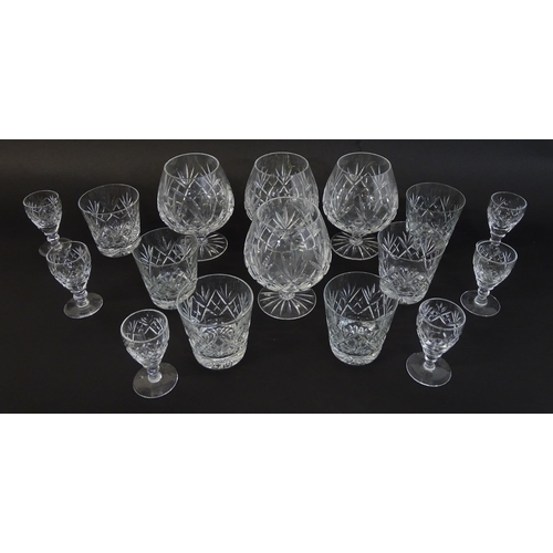 303 - A large quantity of cut glass / crystal glassware to include champagne flutes,  assorted drinking gl... 