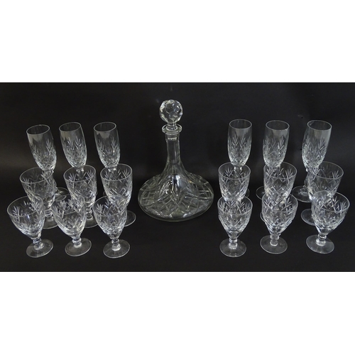 303 - A large quantity of cut glass / crystal glassware to include champagne flutes,  assorted drinking gl... 