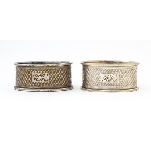 489 - A pair of napkin rings of oval form with engine turned decoration. Hallmarked Birmingham 1952 maker ... 