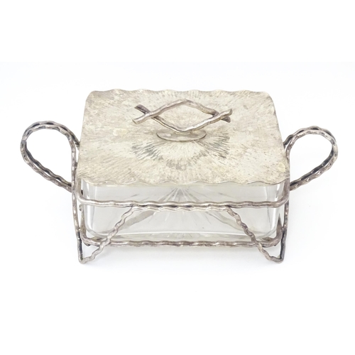 603 - A glass and silver plate butter dish with  textured detail and naturalistic formed handle. Maker Huk... 