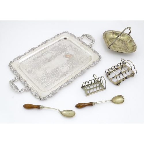 609 - A quantity of assorted silver plated wares comprising toast racks, salad servers, cake basket and tr... 