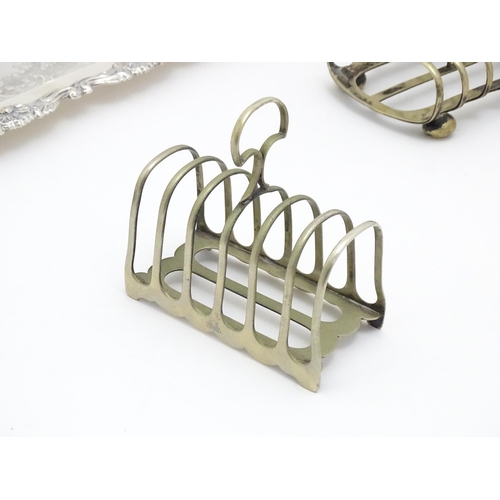 609 - A quantity of assorted silver plated wares comprising toast racks, salad servers, cake basket and tr... 