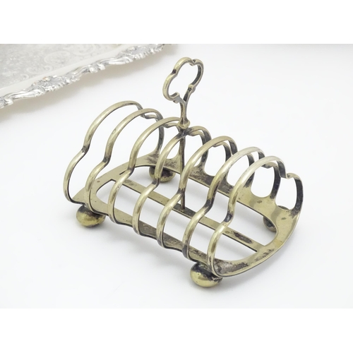 609 - A quantity of assorted silver plated wares comprising toast racks, salad servers, cake basket and tr... 