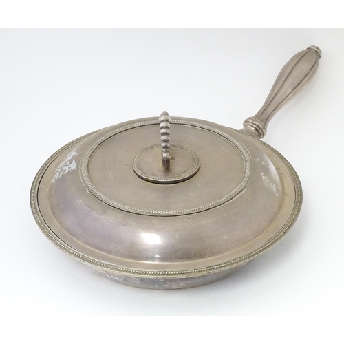 611 - A silver plate lidded warming dish, opening to reveal sections within. Approx. 17