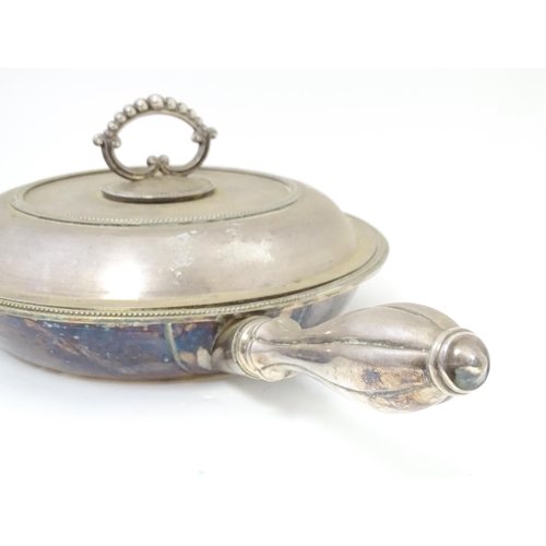 611 - A silver plate lidded warming dish, opening to reveal sections within. Approx. 17