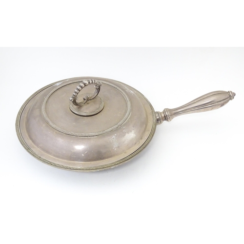 611 - A silver plate lidded warming dish, opening to reveal sections within. Approx. 17