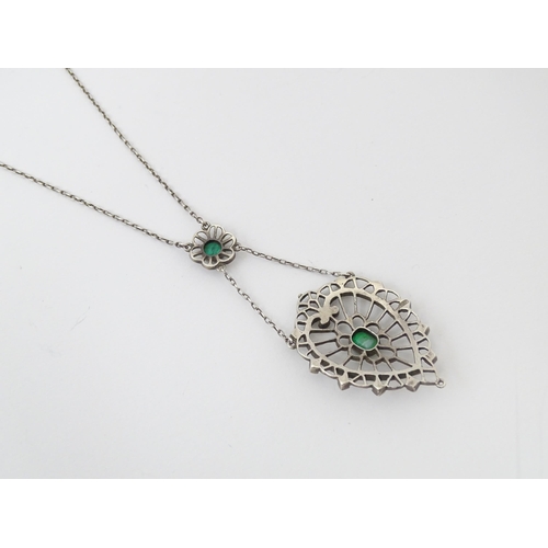 736 - A silver necklace with Art Noveau style pendant set with white enamel,  green stone and marcasite de... 