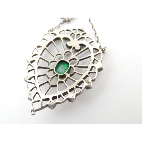 736 - A silver necklace with Art Noveau style pendant set with white enamel,  green stone and marcasite de... 