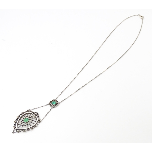 736 - A silver necklace with Art Noveau style pendant set with white enamel,  green stone and marcasite de... 