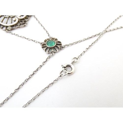 736 - A silver necklace with Art Noveau style pendant set with white enamel,  green stone and marcasite de... 