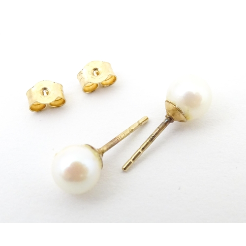 740 - A pair of 9ct gold stud earrings set with pearls. Approx 1/4