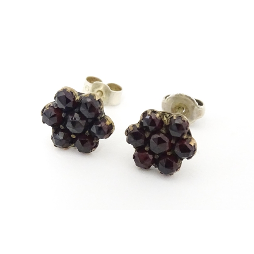 741 - A pair of silver stud earrings decorated with garnets set in gilt metal.  Approx 1/2