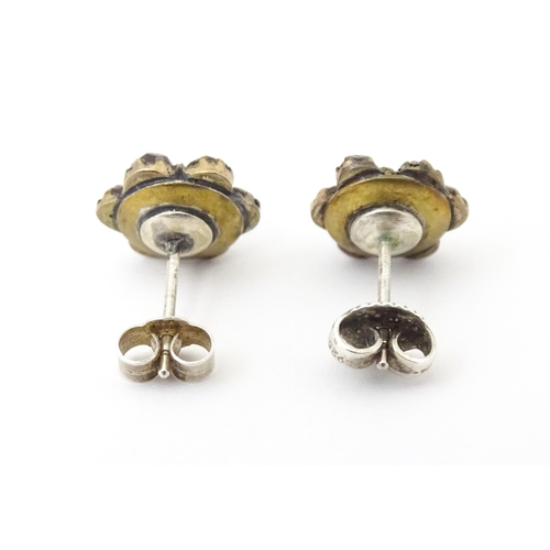 741 - A pair of silver stud earrings decorated with garnets set in gilt metal.  Approx 1/2