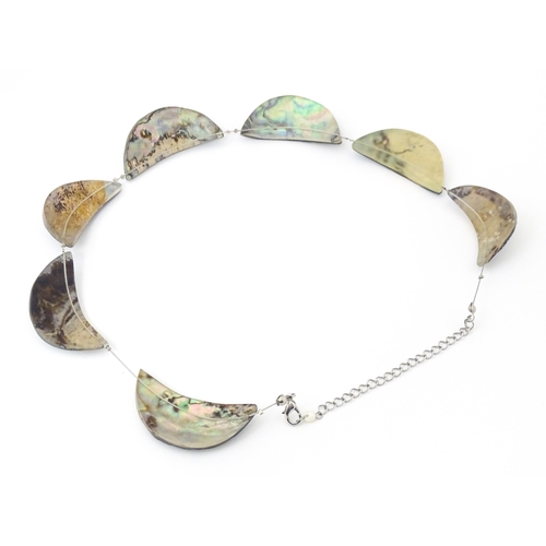 743 - A silver and white metal necklace with silver plate clasp. Together with a necklace with abalone sty... 