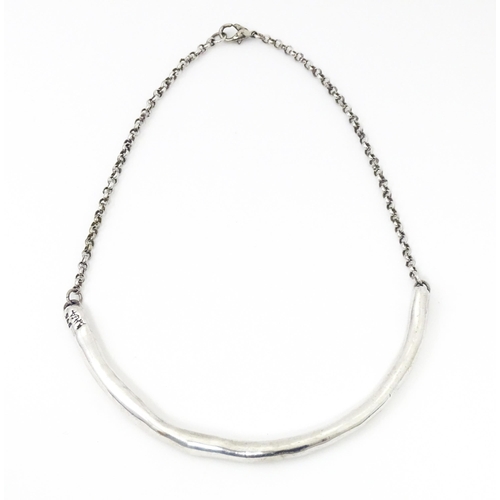 743 - A silver and white metal necklace with silver plate clasp. Together with a necklace with abalone sty... 