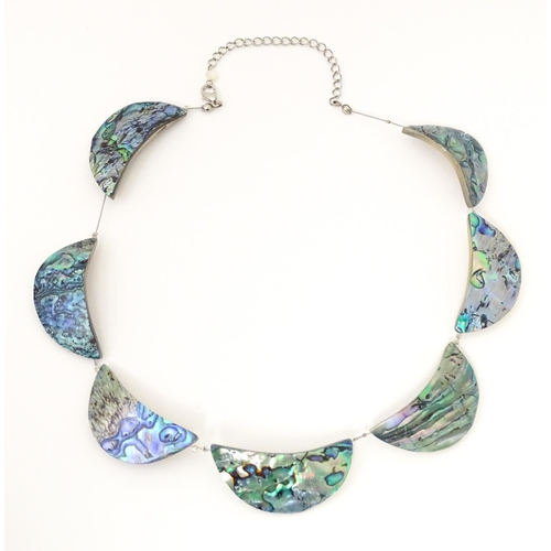 743 - A silver and white metal necklace with silver plate clasp. Together with a necklace with abalone sty... 