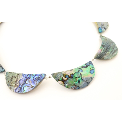 743 - A silver and white metal necklace with silver plate clasp. Together with a necklace with abalone sty... 