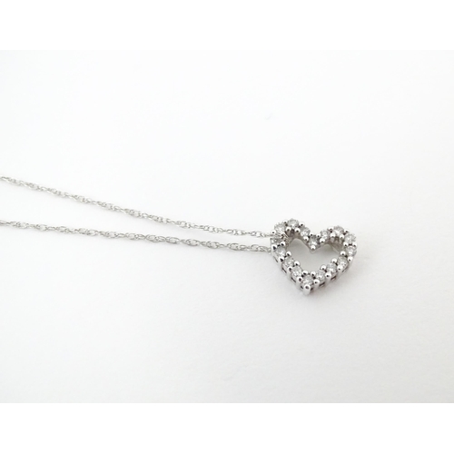 751 - A 14ct white gold pendant of heart form set with diamonds, with a with a 14ct white gold necklace ch... 