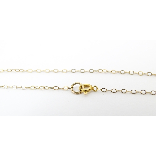 752 - A 9ct gold necklace with pendant drop. The chain 16