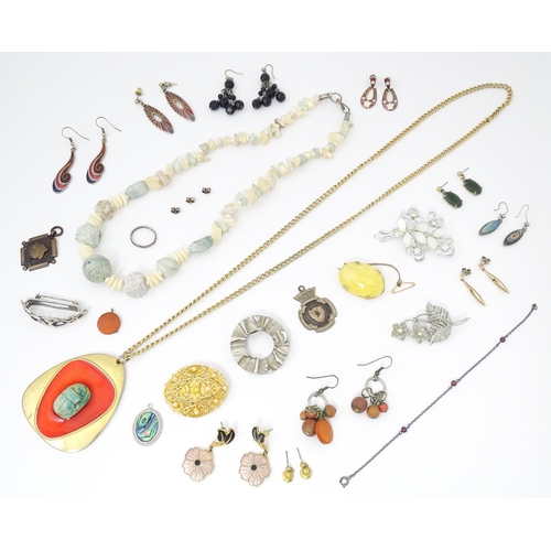 755 - A quantity of assorted costume jewellery to include a pendant with enamel detail and central model o... 