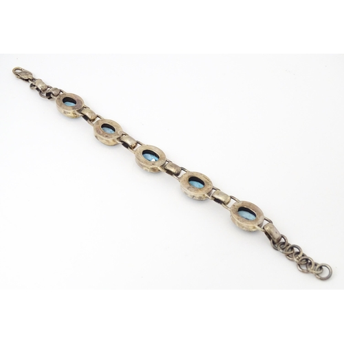 757 - A silver bracelet set with 5 oval cut topaz.