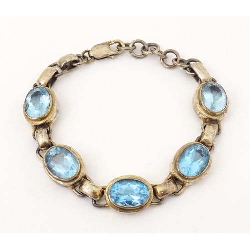 757 - A silver bracelet set with 5 oval cut topaz.