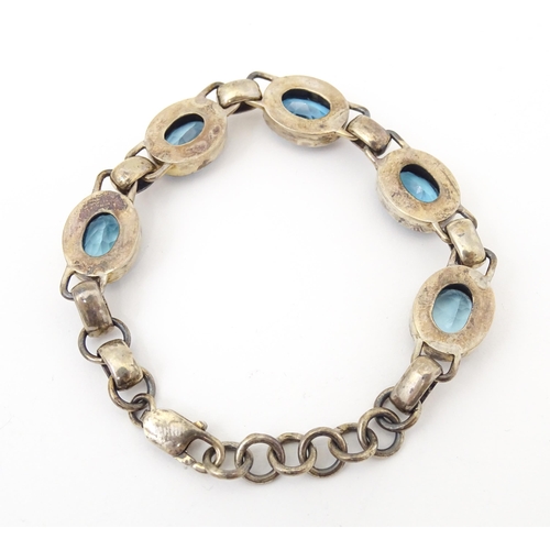 757 - A silver bracelet set with 5 oval cut topaz.