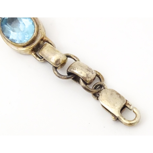 757 - A silver bracelet set with 5 oval cut topaz.