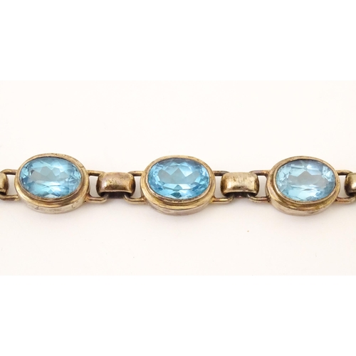 757 - A silver bracelet set with 5 oval cut topaz.