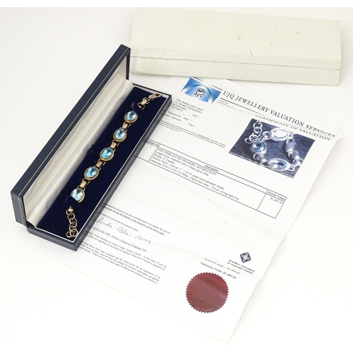 757 - A silver bracelet set with 5 oval cut topaz.