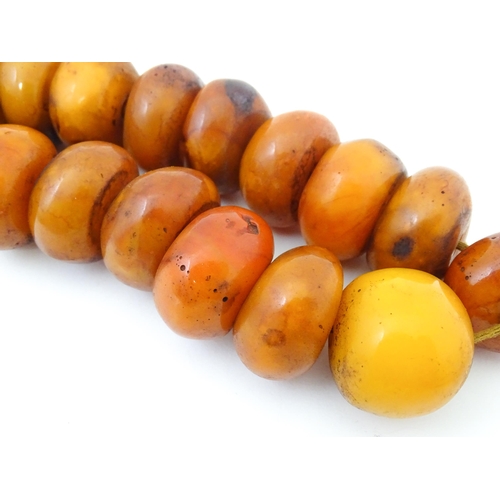 794 - A necklace of large amber coloured beads. Approx 22