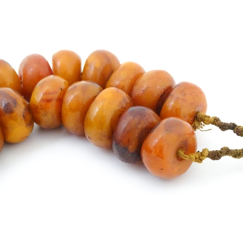 794 - A necklace of large amber coloured beads. Approx 22