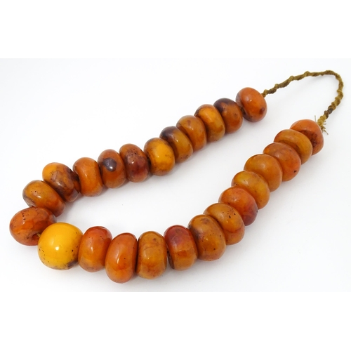 794 - A necklace of large amber coloured beads. Approx 22