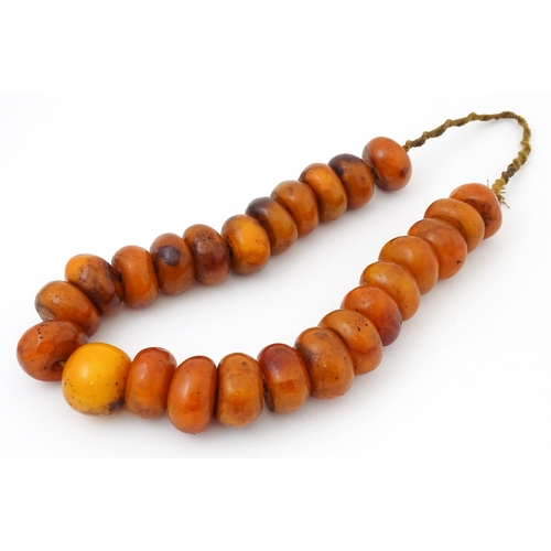 794 - A necklace of large amber coloured beads. Approx 22