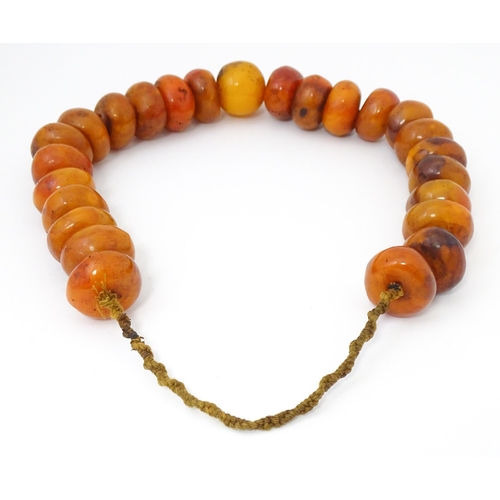 794 - A necklace of large amber coloured beads. Approx 22