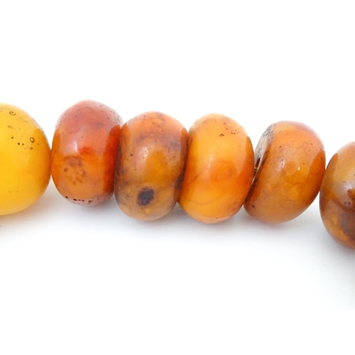 794 - A necklace of large amber coloured beads. Approx 22