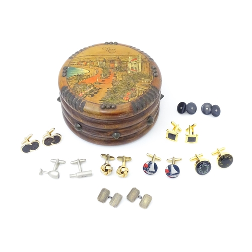 797 - A quantity of assorted cufflinks to include a silver gilt pair, contained within a novelty souvenir ... 