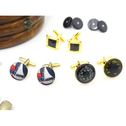 797 - A quantity of assorted cufflinks to include a silver gilt pair, contained within a novelty souvenir ... 