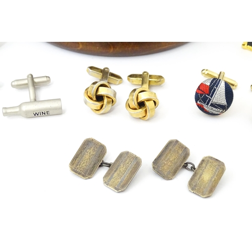 797 - A quantity of assorted cufflinks to include a silver gilt pair, contained within a novelty souvenir ... 