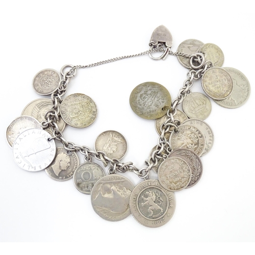 800 - A silver and white metal bracelet set with various coin formed pendant charms and a gilt metal penda... 