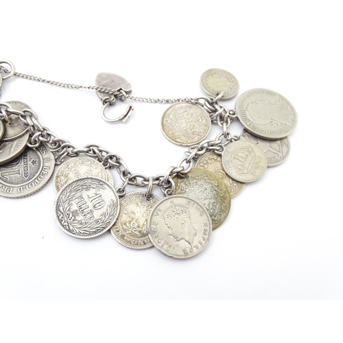 800 - A silver and white metal bracelet set with various coin formed pendant charms and a gilt metal penda... 