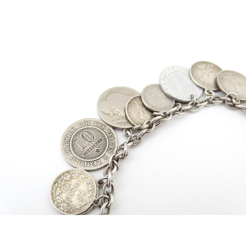 800 - A silver and white metal bracelet set with various coin formed pendant charms and a gilt metal penda... 