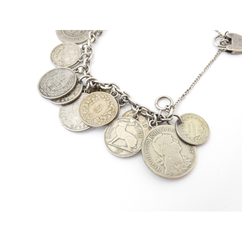 800 - A silver and white metal bracelet set with various coin formed pendant charms and a gilt metal penda... 