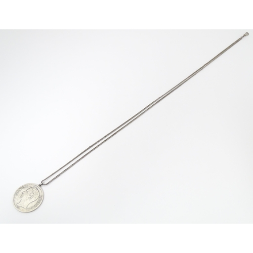 803 - A white metal longuard / watch chain with pendant formed from a silver Venezuelan coin dated 1921 an... 