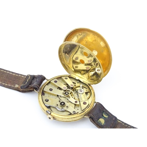 814 - An 18ct gold pocket watch converted into a wristwatch, with engraved floral and scroll detail. The d... 