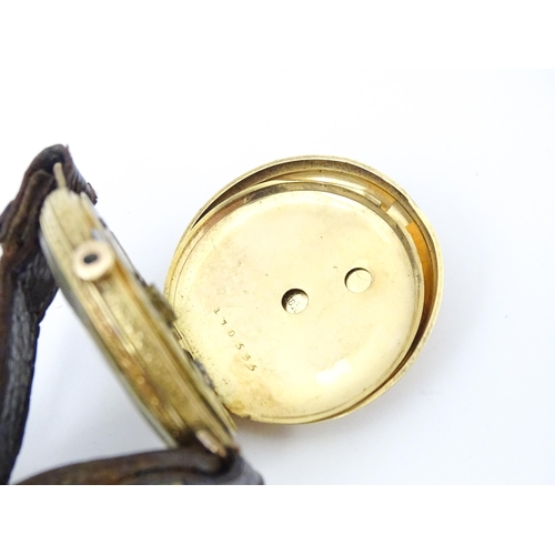 814 - An 18ct gold pocket watch converted into a wristwatch, with engraved floral and scroll detail. The d... 