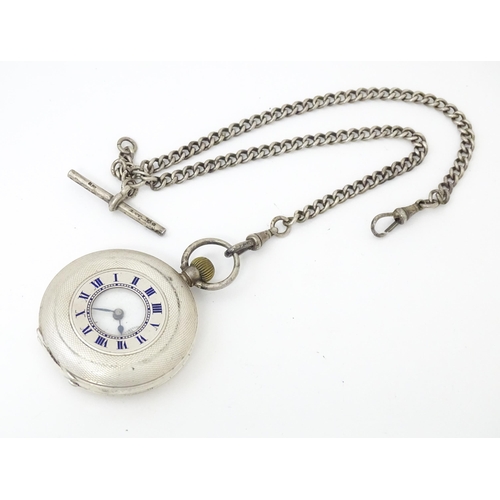 834 - An Omega half hunter silver pocket watch with blue enamel numerals  and engine turned decoration. Th... 