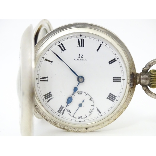 834 - An Omega half hunter silver pocket watch with blue enamel numerals  and engine turned decoration. Th... 